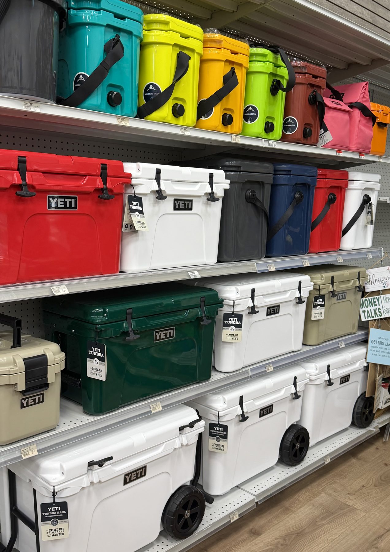 Colorful YETI Tundra hard coolers, Roadie coolers, and YETI Tundra Haul wheeled coolers on display at Hessler Paint & Hardware in Delray Beach, Florida.