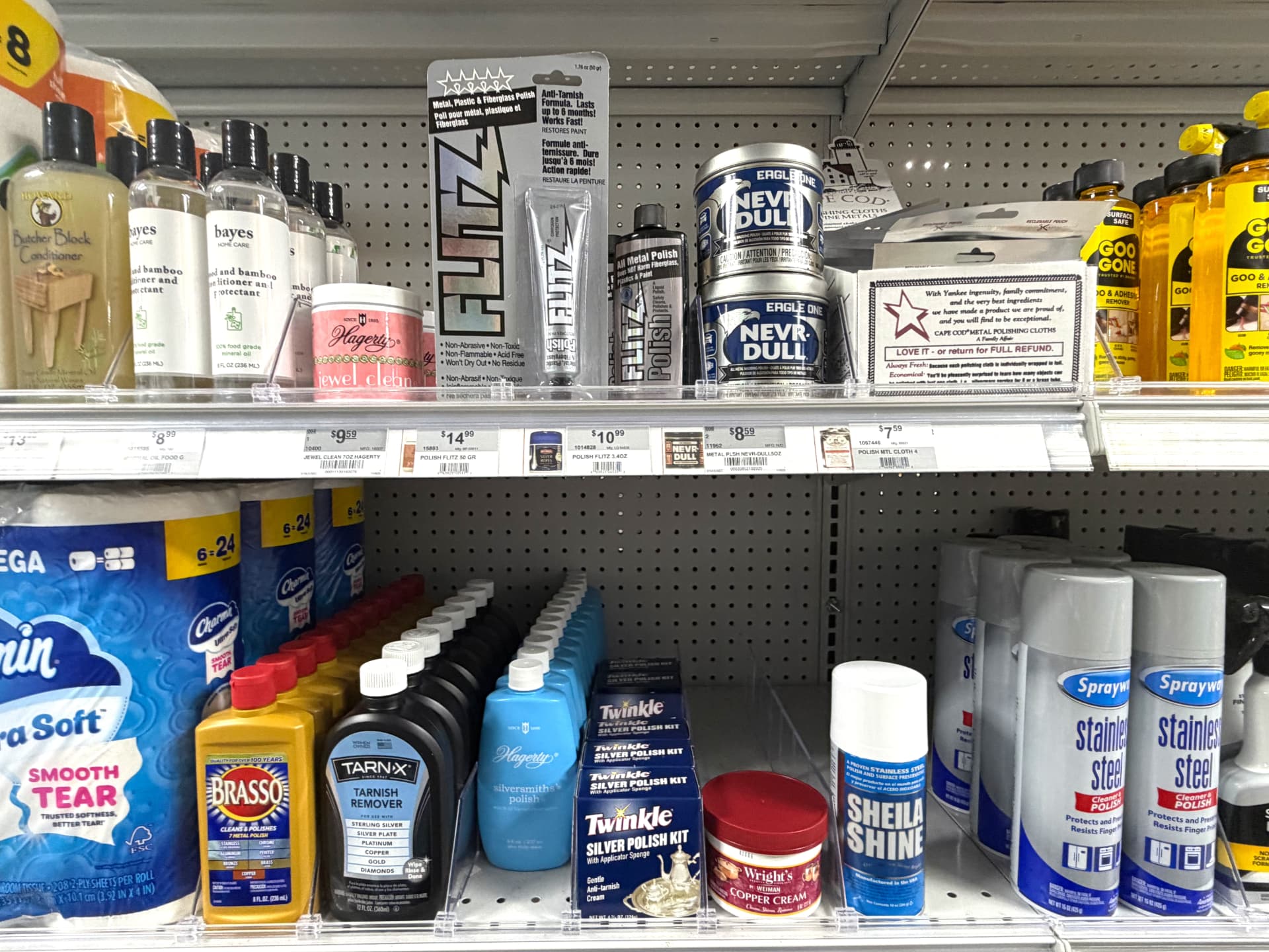 Metal polish shelf with Brasso, Tarn-X, Flitz, Nevr-Dull and Sheila Shine