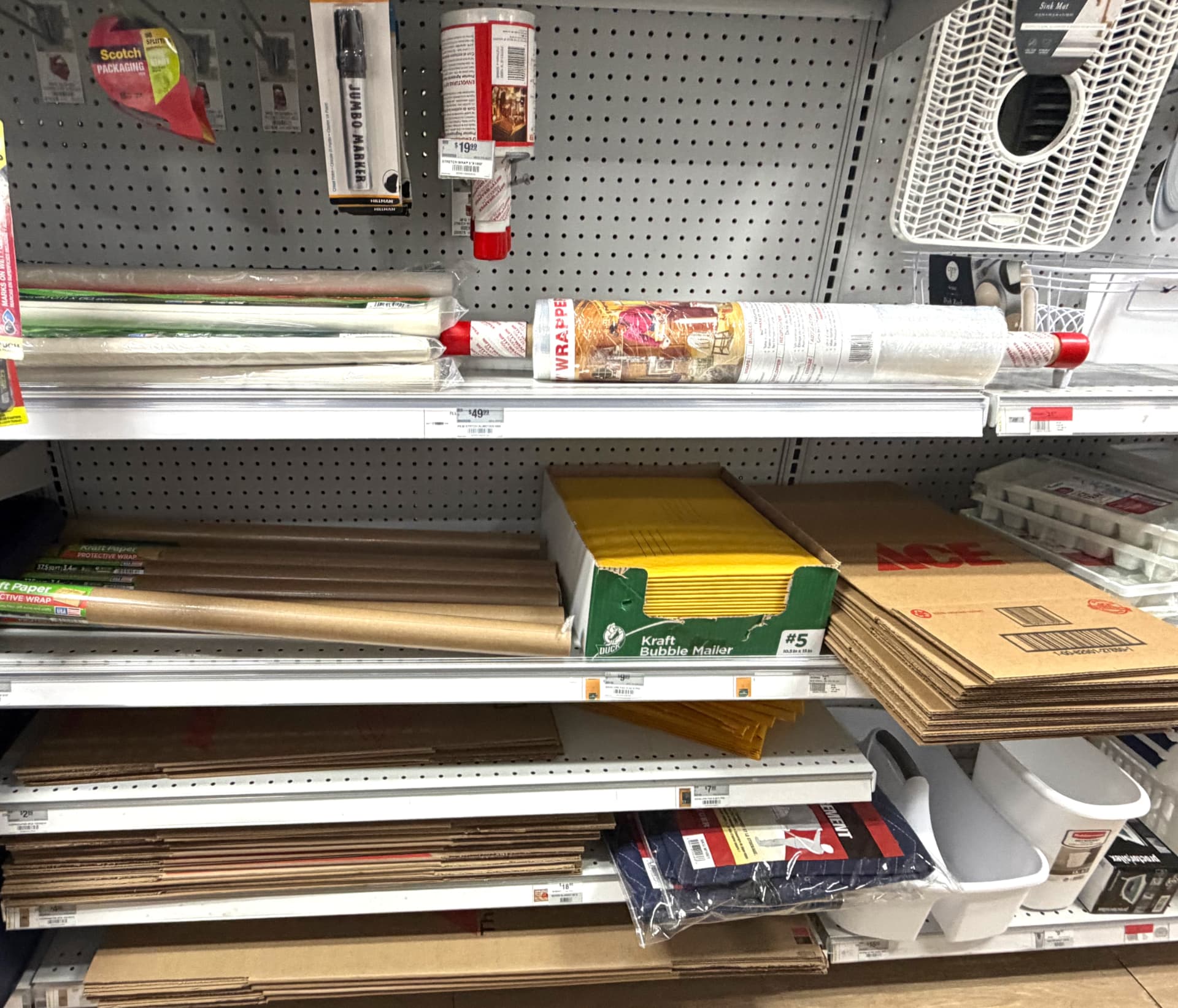 Moving and packing supplies including kraft paper, stretch wrap, bubble mailers and flat cardboard boxes