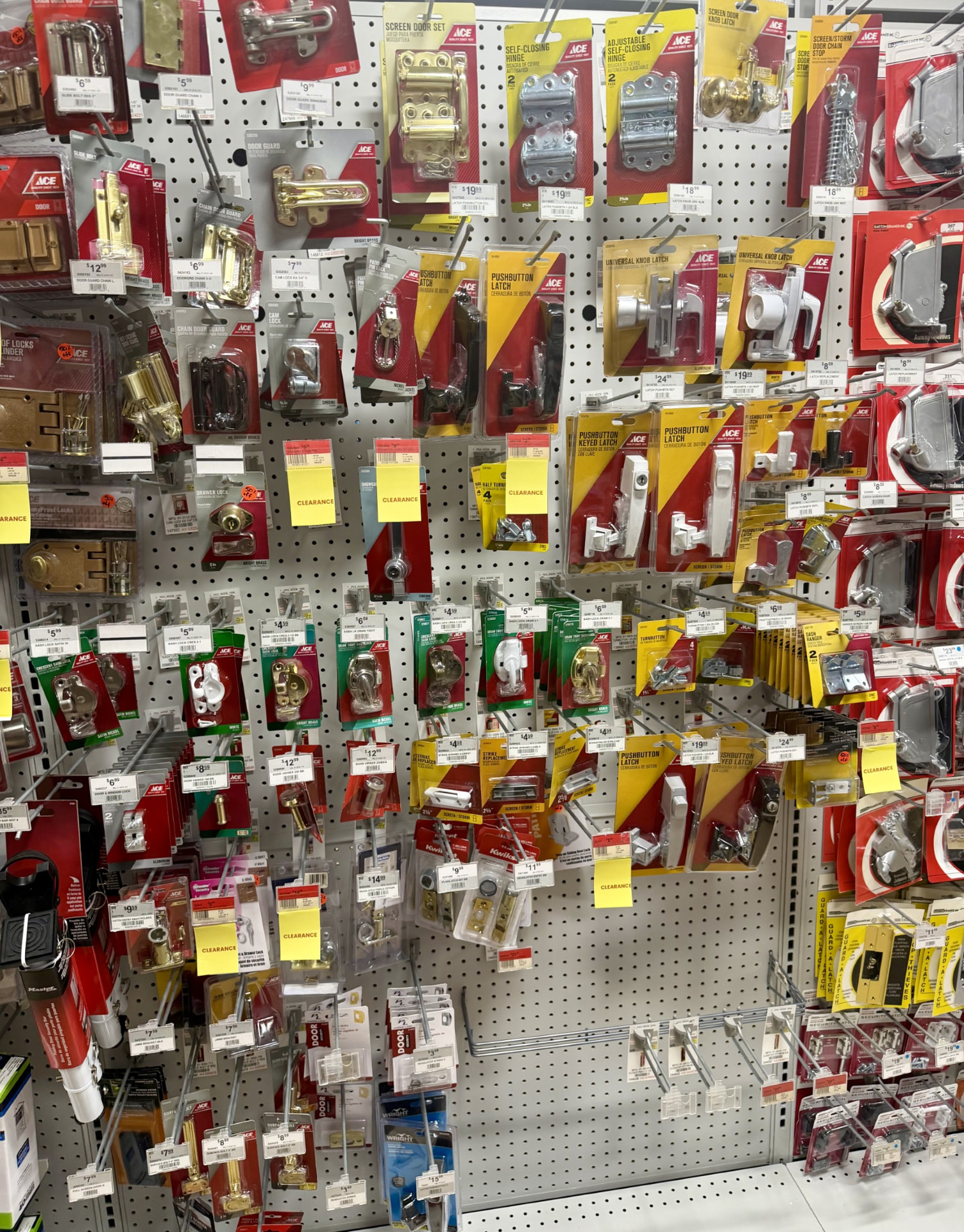 Screen and storm door latches, chain guards, hinges and sash locks on pegboard