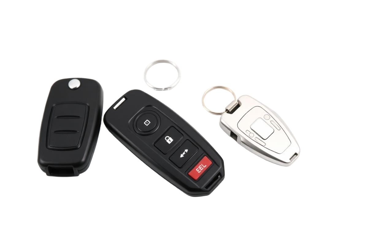 Automotive keys we duplicate: a flip transponder key, a keyless entry remote, and a smart fob